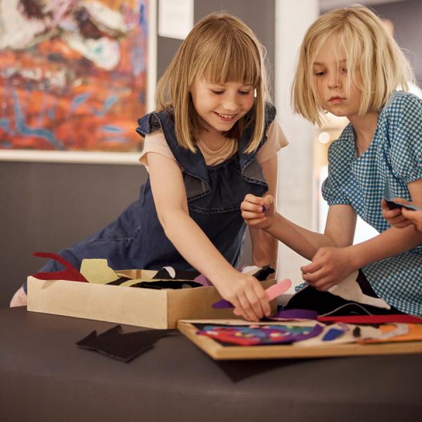 Two girls have fun making a collage at Trapholt